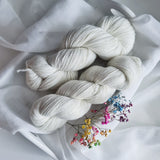 Luxurious undyed 4 ply yarn, 75% superwash merino (extra fine), 15% nylon, 10% silver stellina, 400m/100g, 4/16 NM